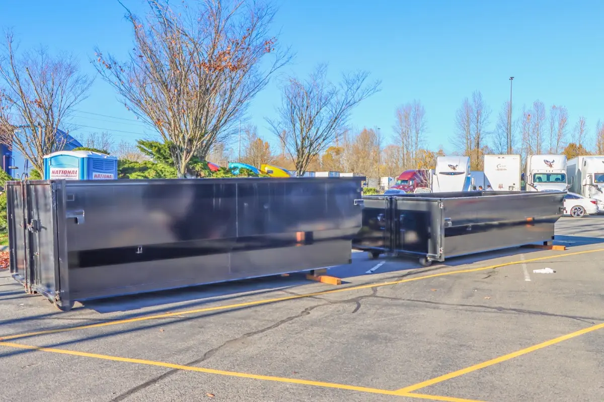 Professional dumpster rental service with roll-off container on residential driveway in Somerville